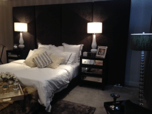 bedroom with moody, luxe colours and lighting