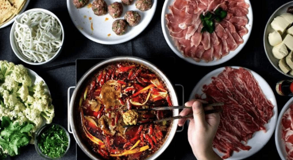 Chinese hot pot with mixed food platters